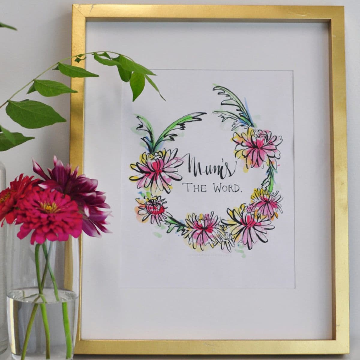 Gold-framed fall printable featuring a colorful floral wreath and the phrase