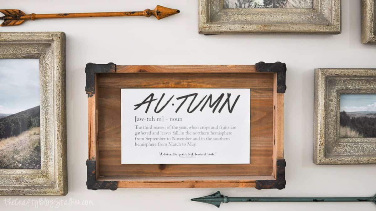 Looking for easy Fall Decor? This Autumn Definition Printable along with over 35 more is the perfect way to easily add a little Fall Decor to your home. Autumn definition printable displayed in a rustic wood frame as part of a fall gallery wall with landscape photos and decorative arrows.