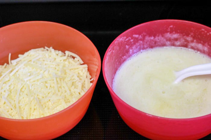 red bowls with melted butter and shredded parmesan cheese