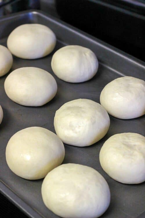 thawed rolls on a baking sheet
