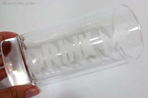 clean drinking glass with "drink me" etched into the side