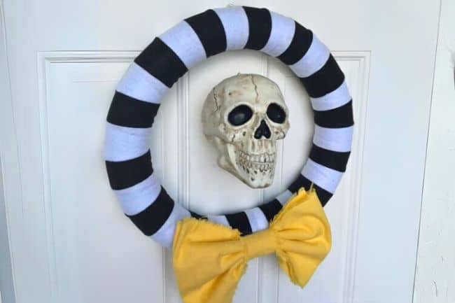 Halloween skull wreath hanging on a door.