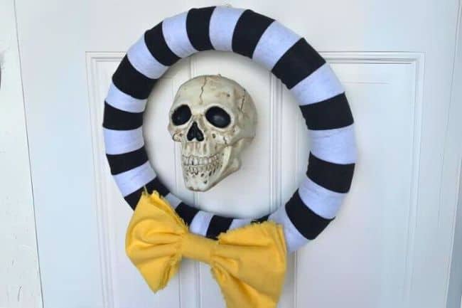 Halloween skull wreath hanging on a door.