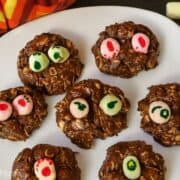 A plate of fun no-bake Nutella Monster Cookies topped with colorful marshmallow "eyes," perfect for a spooky treat that kids will love to make and eat!