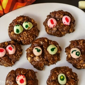A plate of fun no-bake Nutella Monster Cookies topped with colorful marshmallow "eyes," perfect for a spooky treat that kids will love to make and eat!