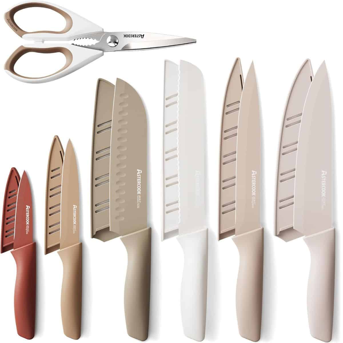 A 13-piece kitchen knife set with color-coordinated knives, blade covers, and kitchen shears in neutral tones of beige, white, and brown.