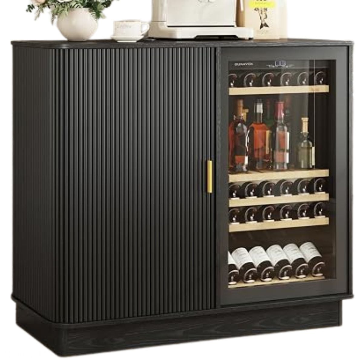 Black coffee bar cabinet with a ribbed door, gold handle, and glass-front wine cooler filled with bottles, topped with a coffee machine and decor.