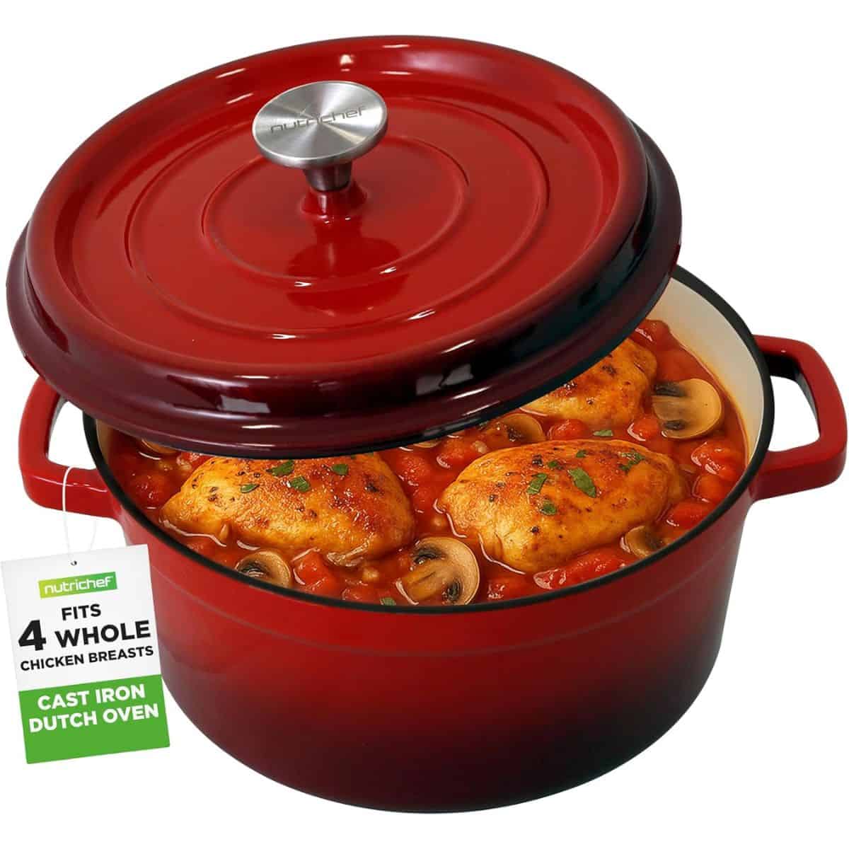 A red enameled cast iron Dutch oven filled with chicken breasts, tomatoes, and mushrooms, shown with the lid slightly open.