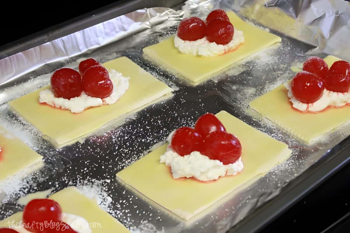 Puff pastry with cream cheese, cherries and sugar.