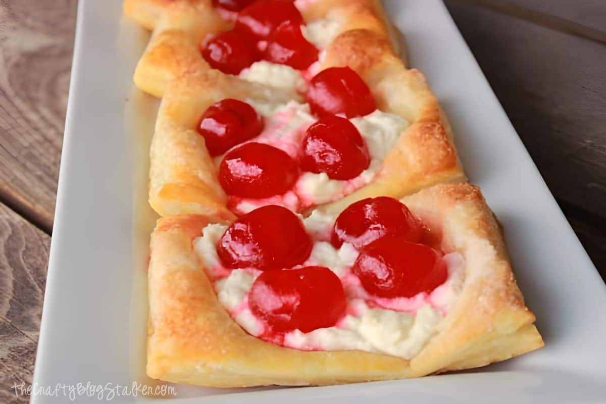 Cherry Cream Cheese Pastries on a white plate.