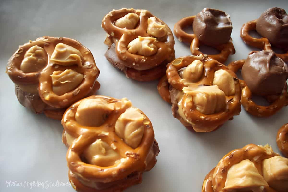 Pretzel sandwiches with peanut butter and snickers pieces.