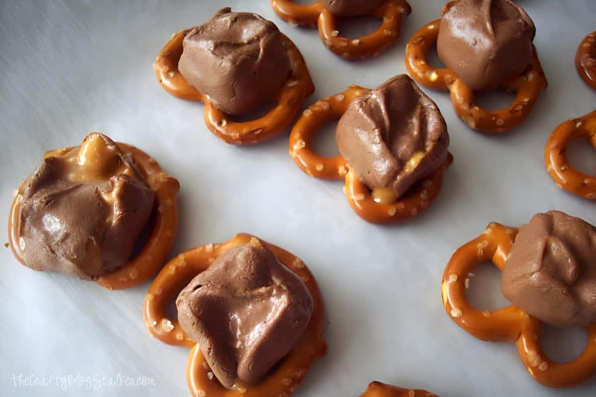 Pretzels with melted Snickers pieces on top.