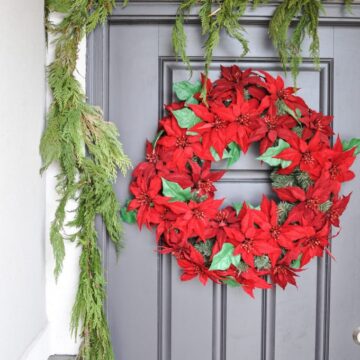 Looking for simple Porch Decorating Ideas? Create a classic appeal with these traditional poinsettias and cedar garland for a Classic Christmas Porch.