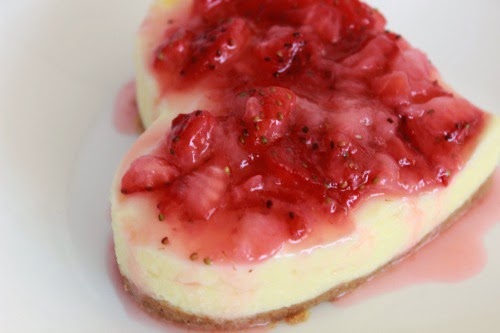 side view of an individual Cheesecake Heart with Strawberry Sauce