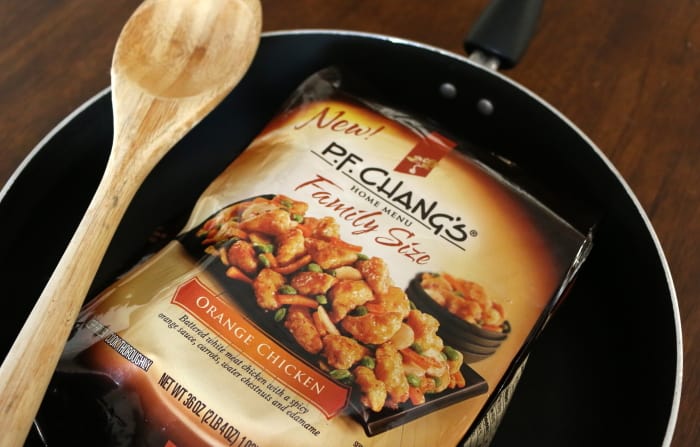 P.F. Chang's Home Menu frozen meal in the package in a pan with a wood spoon