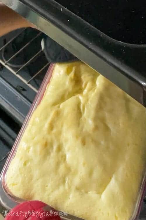 Pulling lemon bars out of the oven.