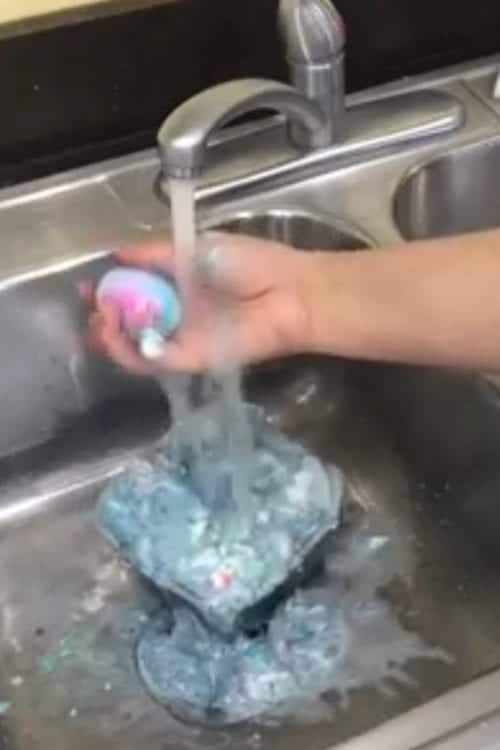 rinsing the eggs off under a running water faucet