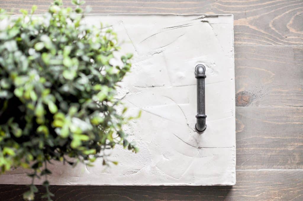Learn how to create this gorgeous DIY Concrete Tray & some tips for working with concrete. Create different shapes and customize with handles!
