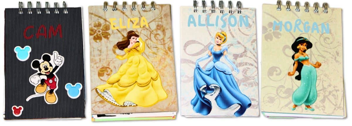 Four personalized Disney autograph books featuring Mickey Mouse, Belle, Cinderella, and Jasmine with colorful character designs and names on covers.