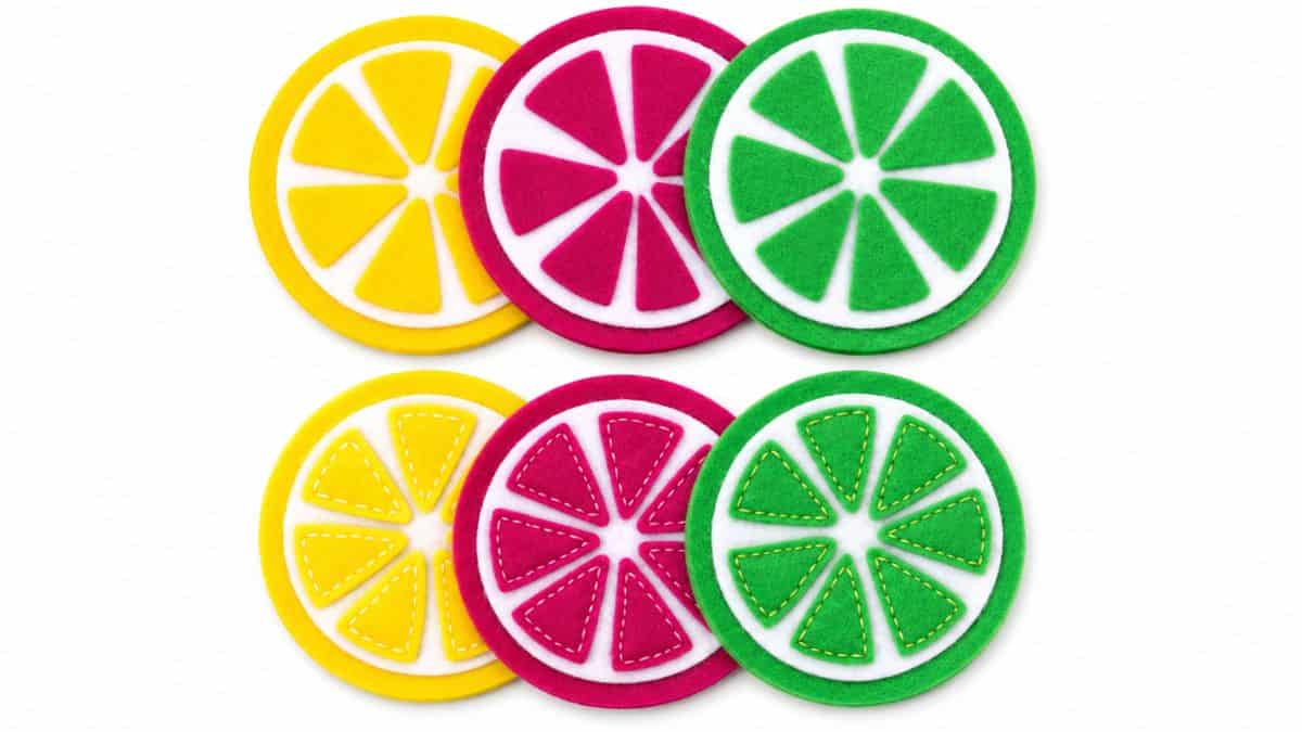 Colorful felt citrus slice coasters in yellow, pink, and green displayed in layered sets on a light gray background.