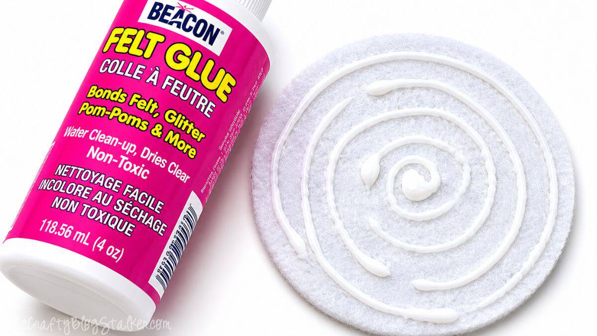 Bottle of Beacon Felt Glue beside a white felt coaster base with glue applied in a spiral pattern for assembling DIY citrus coasters.
