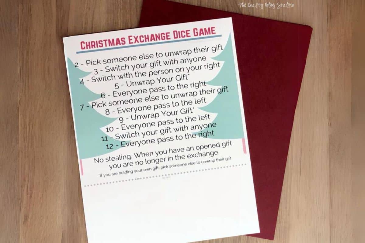 Christmas Gift Exchange Dice Game PDF and a sheet of red cardstock.