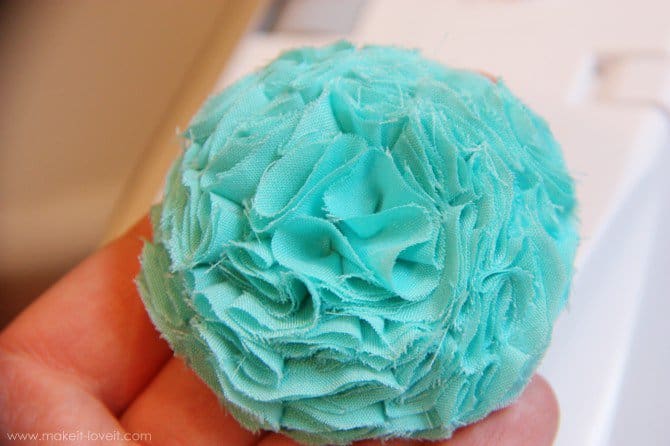 Teal textured fabric flower.