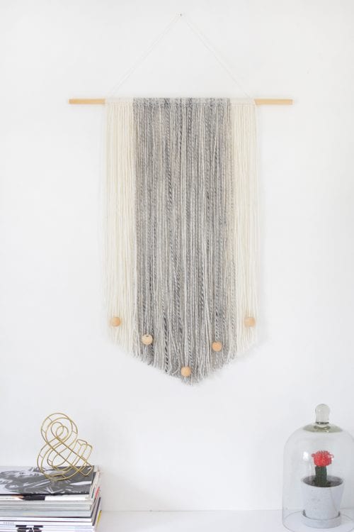 White and gray yarn wall hanging.