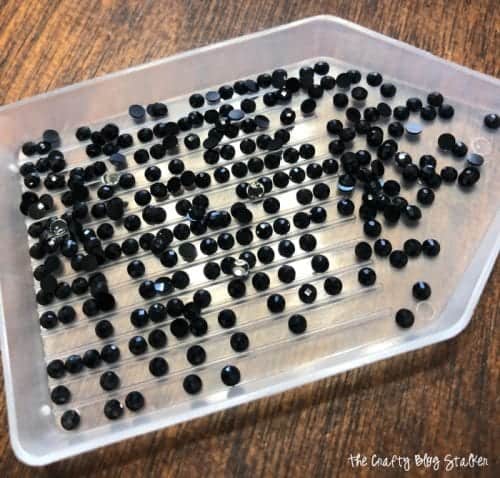 small black plastic diamonds in the sorting tray