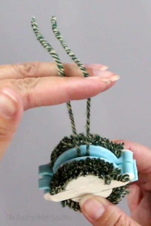 How to Make Pom Poms with the We R Memory Keepers Pom Pom Maker, a tutorial featured by top US craft blog, The Crafty Blog Stalker: yarn ends