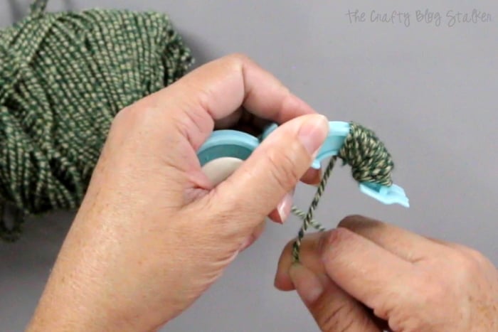 How to Make Pom Poms with the We R Memory Keepers Pom Pom Maker, a tutorial featured by top US craft blog, The Crafty Blog Stalker: wrapping yarn