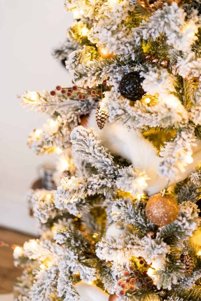 This Flocked White and Copper Christmas Tree brings coziness into any space! Learn how to decorate a tree with these simple tips! 