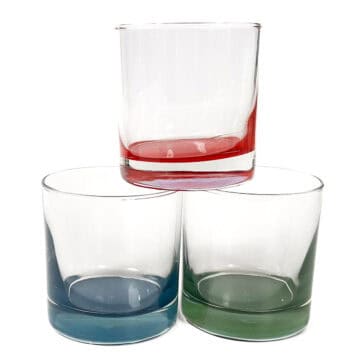Three clear glasses with colored bases in blue, green, and red stacked in a pyramid arrangement on a white background.