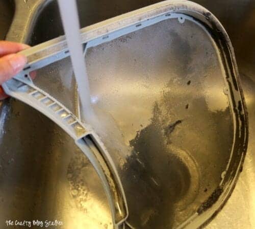 cleaning a lint trap under water