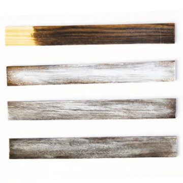 Four wood boards showing the weathered wood finish process, from dark stained wood to dry brushed and distressed planks arranged on a white background.