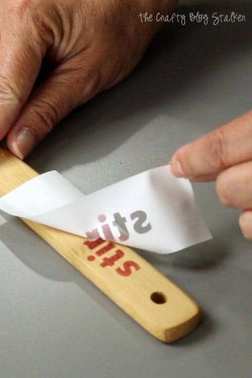 removing the vinyl stencil from the handle of the wood spoons