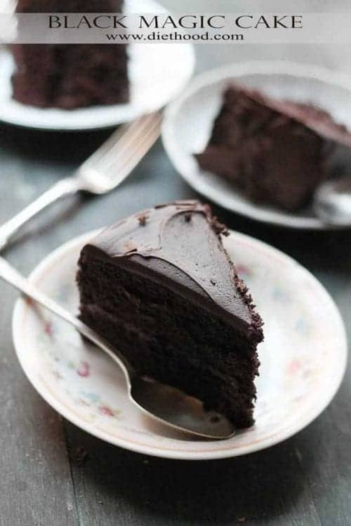 a slice of black magic cake on a plate with a spoon