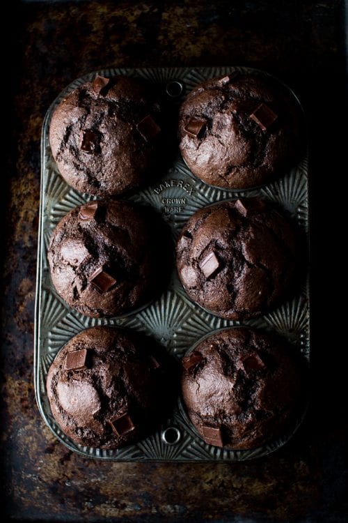 a cupcake tin with 6 dark chocolate banana rye muffins