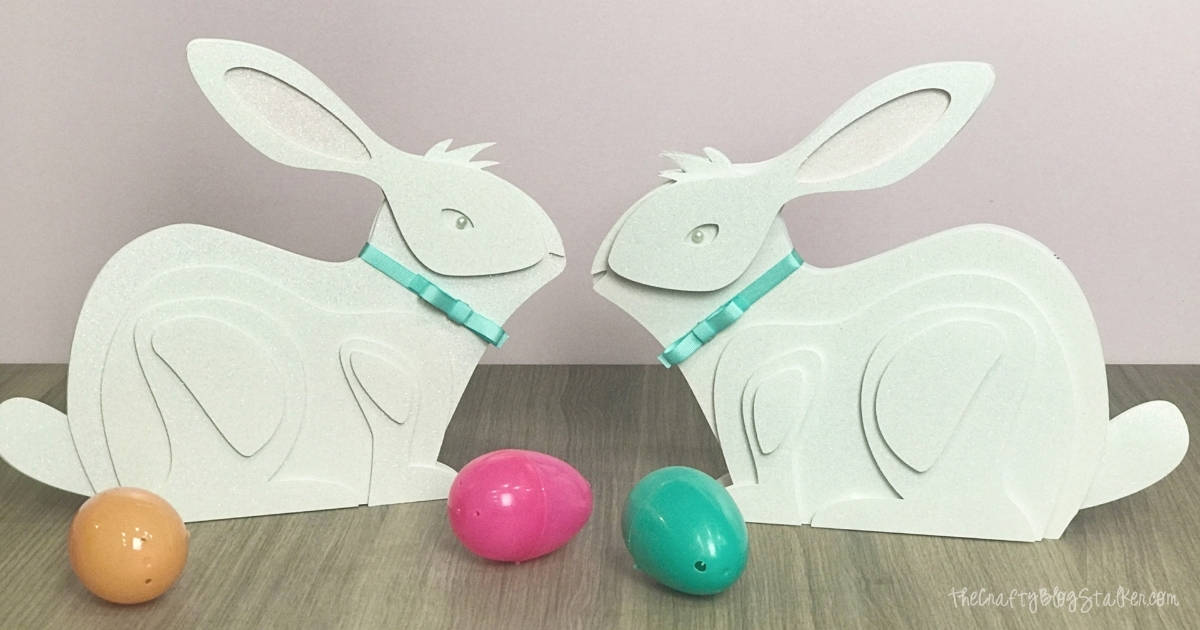 Two paper art bunnies face to face.