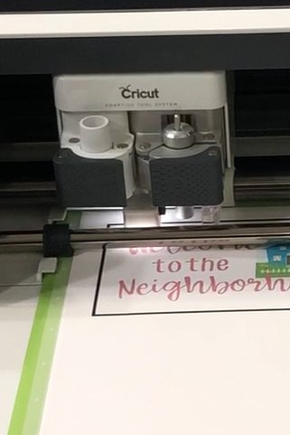 How to Print and Cut in Cricut Design Space by popular US craft blog, The Crafty Blog Stalker: image of a label being printed off in a Cricut machine. 