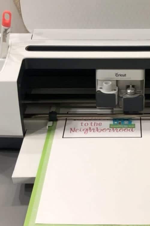 How to Print and Cut in Cricut Design Space by popular US craft blog, The Crafty Blog Stalker: image of a label being printed off in a Cricut machine. 