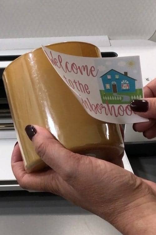 How to Print and Cut in Cricut Design Space by popular US craft blog, The Crafty Blog Stalker: image of a woman applying a label to a candle. 