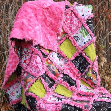 Finished Pink Minky Rag Quilt displayed on a chair.