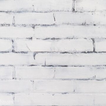 Painted faux brick wall with visible brick texture and mortar lines, styled as a simple background surface.