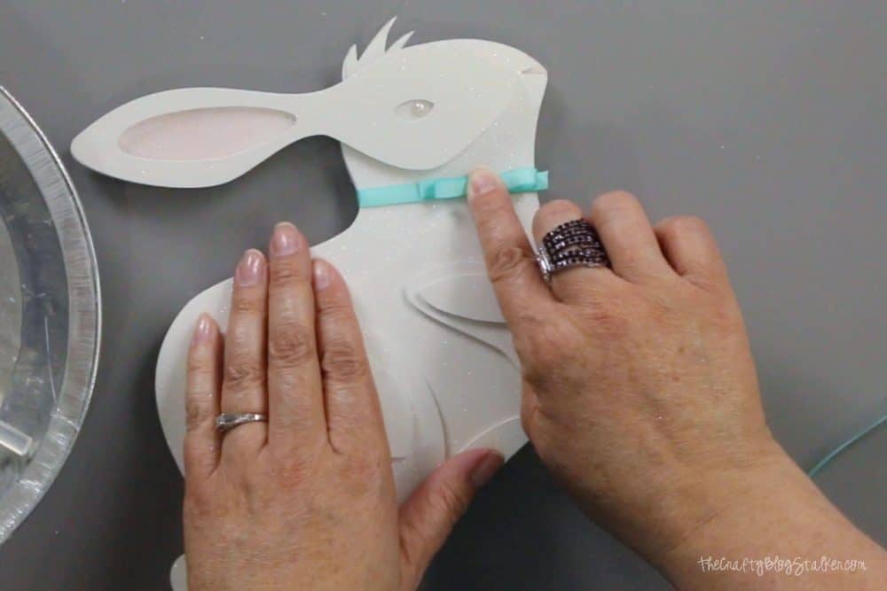 adding a ribbon bow to the neck of the 3d paper art bunny