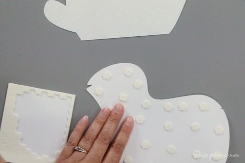 adding adhesive foam dots to the layered paper art