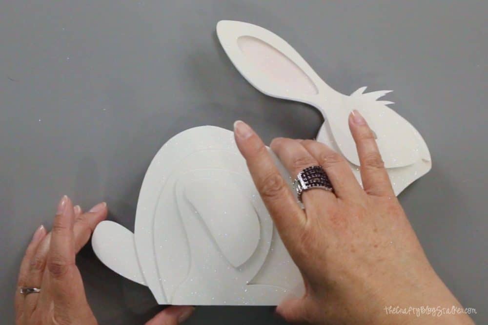 layering the pieces of the 3d paper art bunny