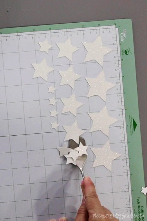 image of cut glitter stars on a cricut cutting mat