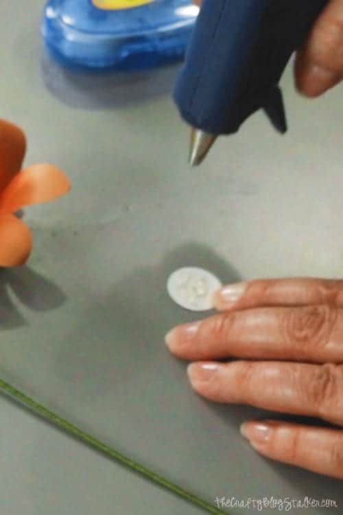 image of hot glue being applied to a paper circle