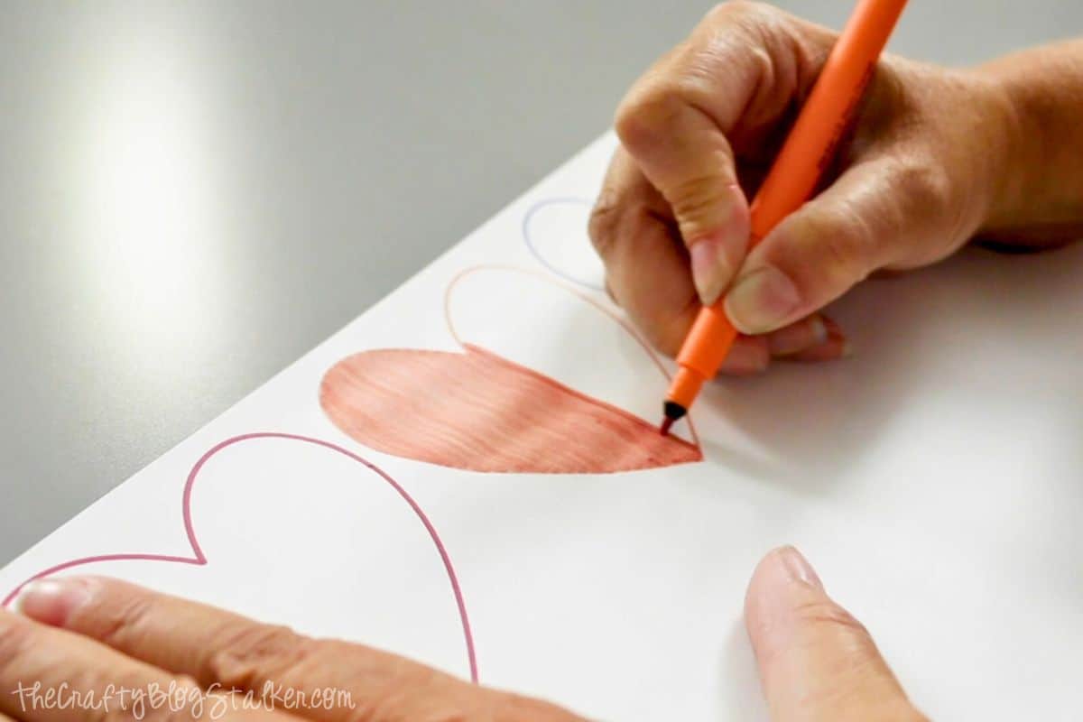 Coloring in a heart shape with an Infusible Ink marker.